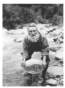 alaskan prospector panning (screening) for gold